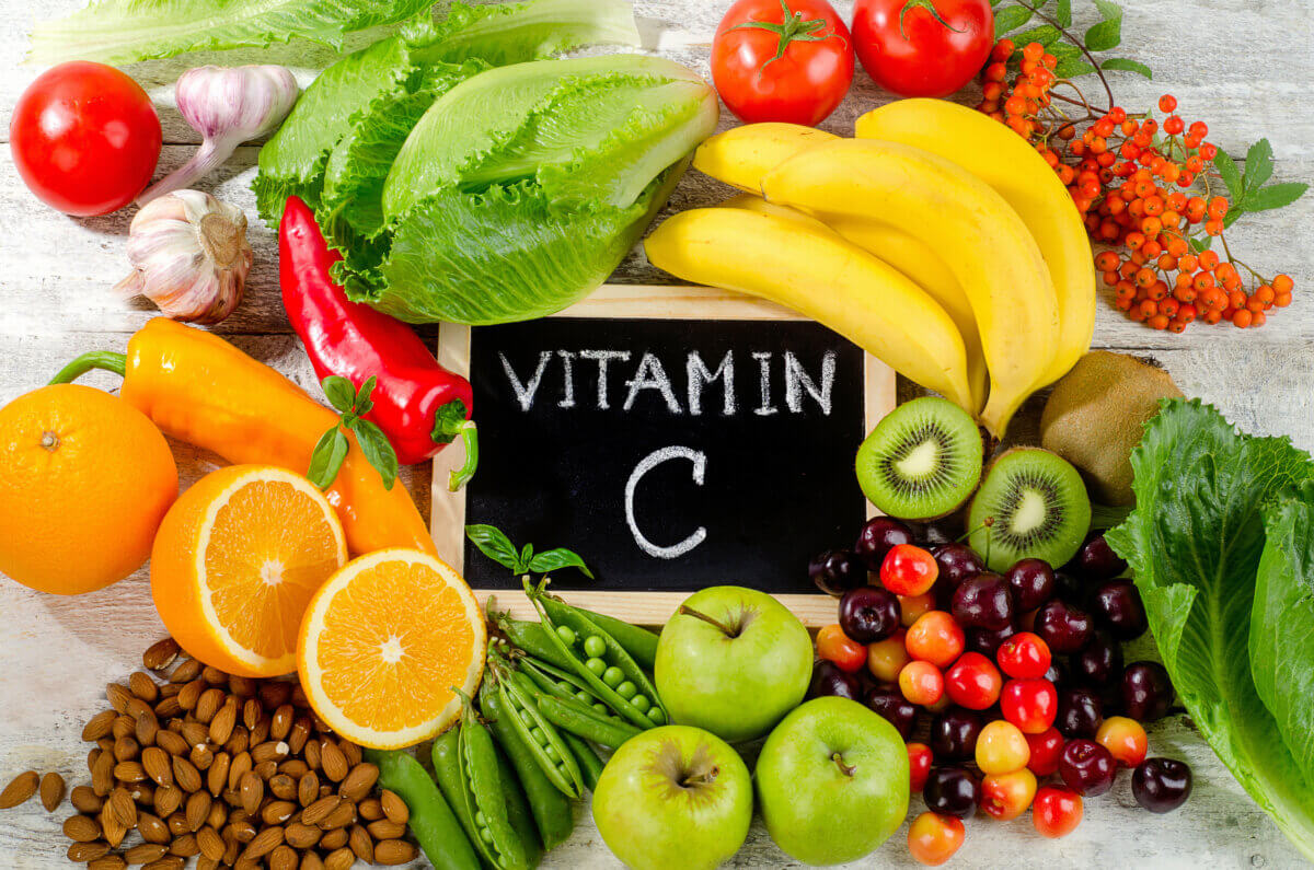 Foods High in vitamin C on a wooden board.