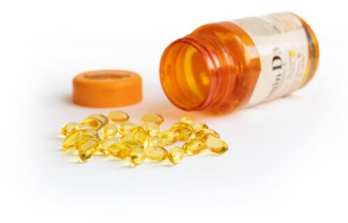 Vitamin D capsules with supplement bottle