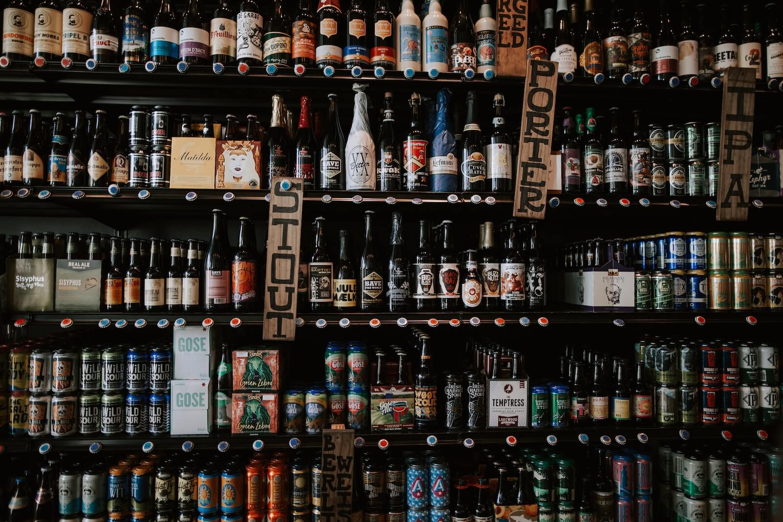 labeled glass alcohol bottles on shelf