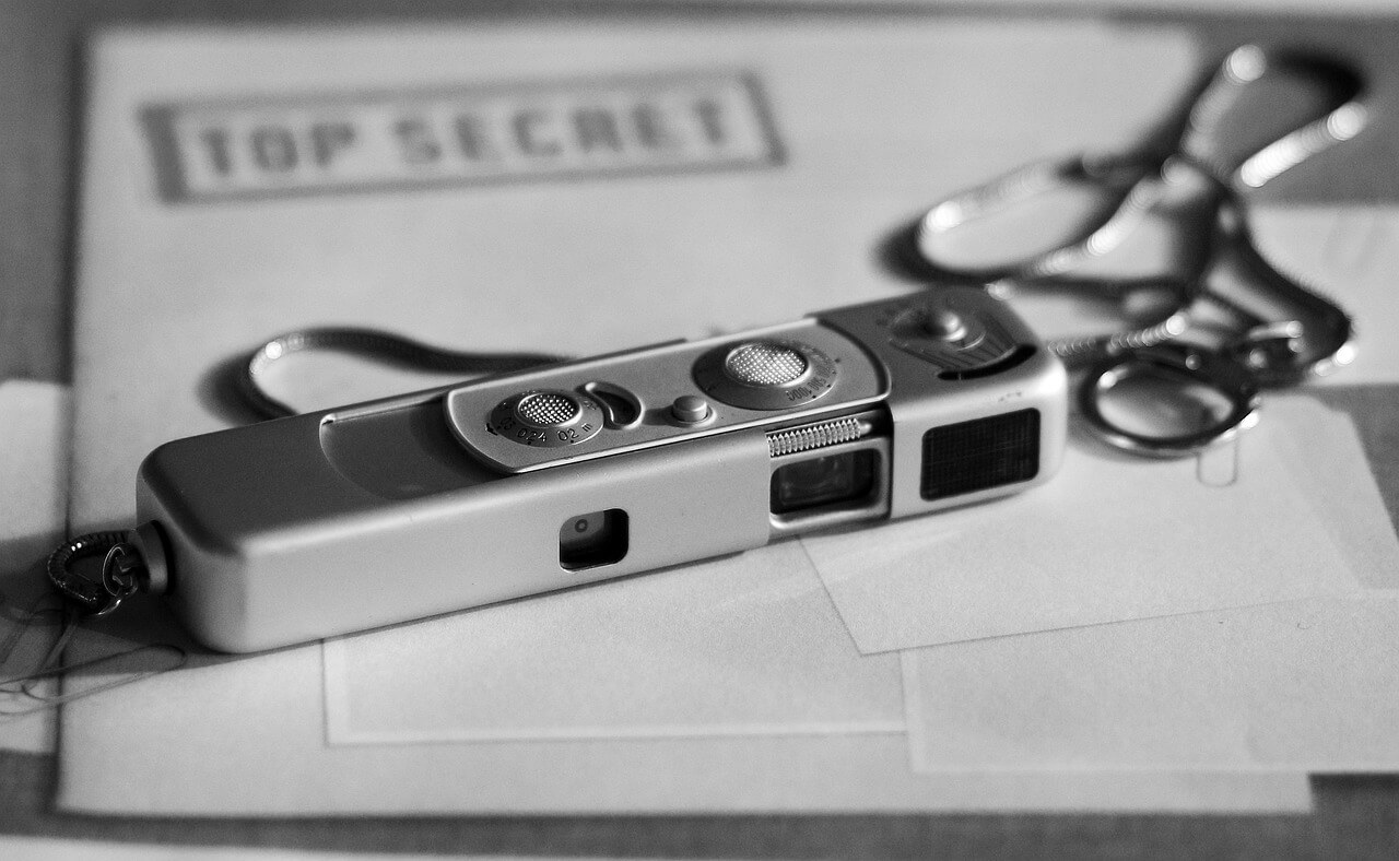 Spy camera on top of top secret classified documents