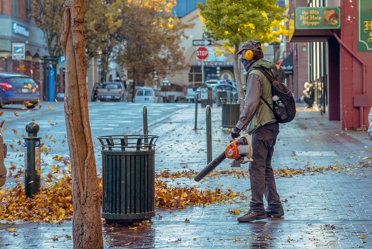 A man leaf blowing a street
