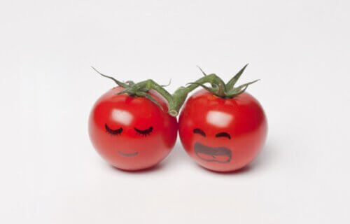 a pair of tomatoes with faces drawn on