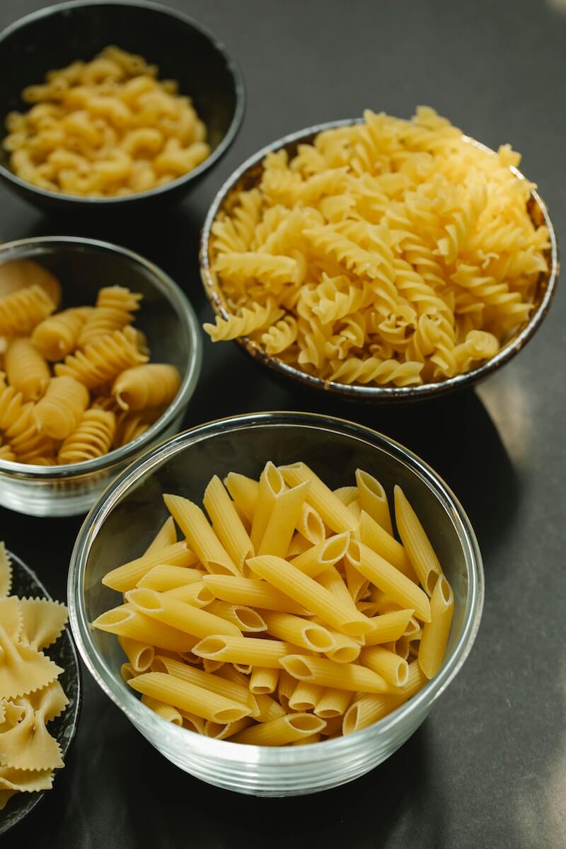 bowls with pasta on table