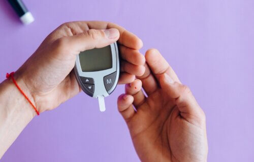 Person Holding a Glucose Meter