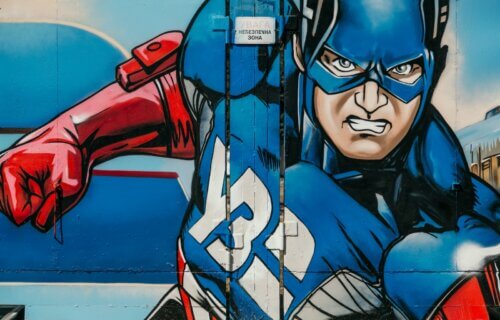 red white and blue graffiti of Captain American painted on a wall