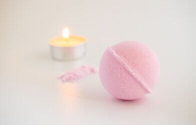pink bath bomb and candle