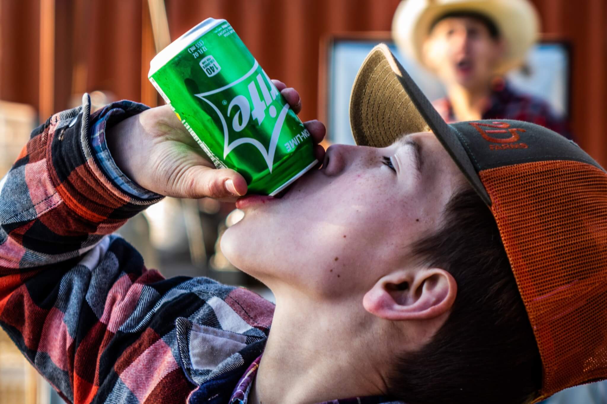 Child drinking a can of Sprite soda