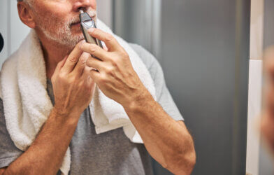 Man using a nose hair trimmer