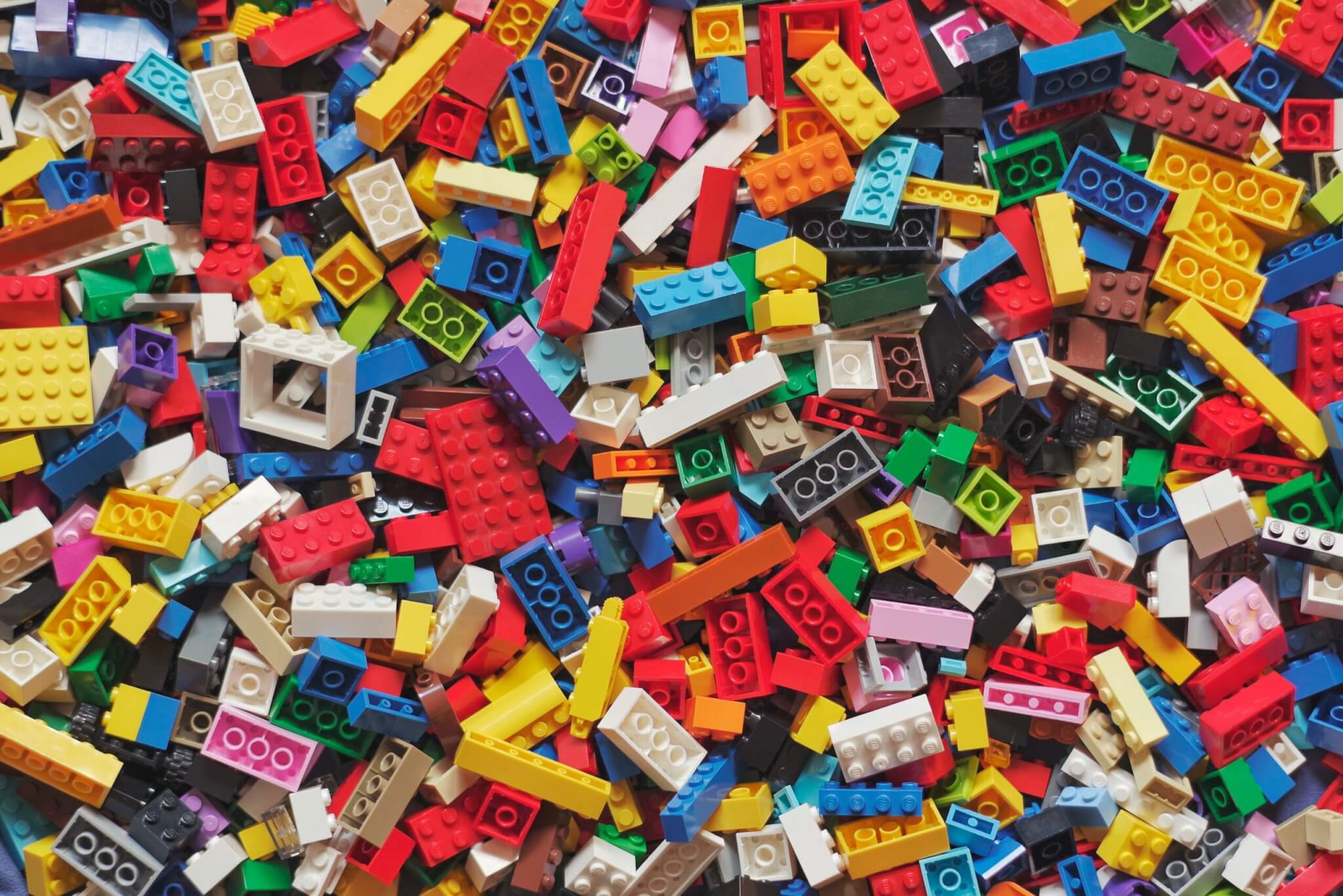 LEGO of all shapes and sizes and colors in a pile (Photo by Xavi Cabrera on Unsplash)