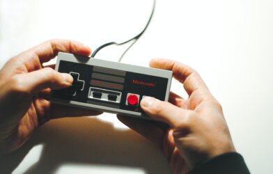 Person playing Nintendo using a NES controller