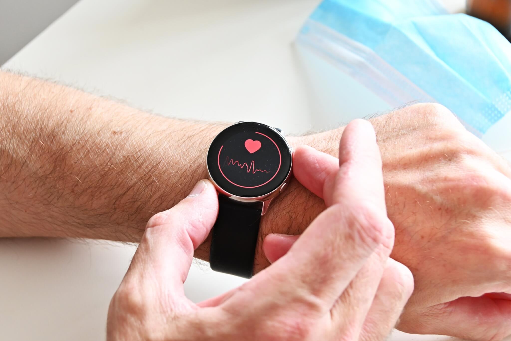 Person checking heart rate on smartwatch