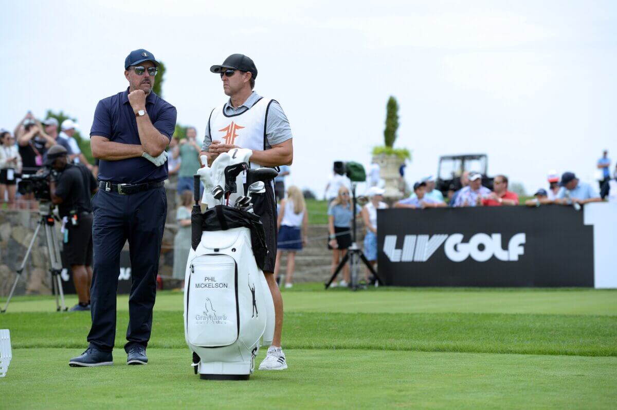 Phil Mickelson (L) talks to his Caddie at the 16th Tee during the LIV Golf Tournament
