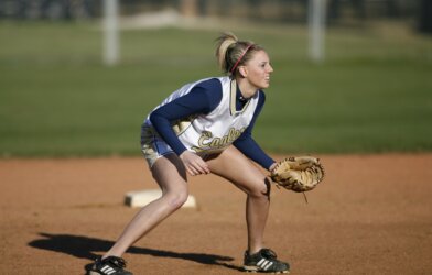 Softball player in the field with glove ready