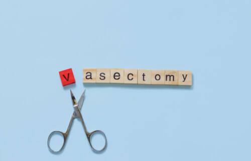 Vasectomy concept featuring scissors and letters