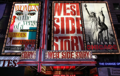 Theater at Times Square at 7th Avenue showing advertisement billboards for Broadway musicals, including West Side Story, in Manhattan