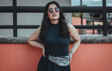 Woman wearing sunglasses and a fanny pack