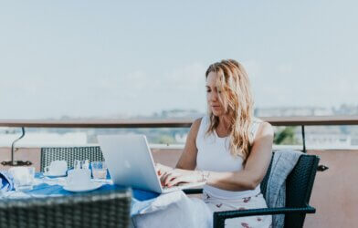 Woman working remotely on laptop outside