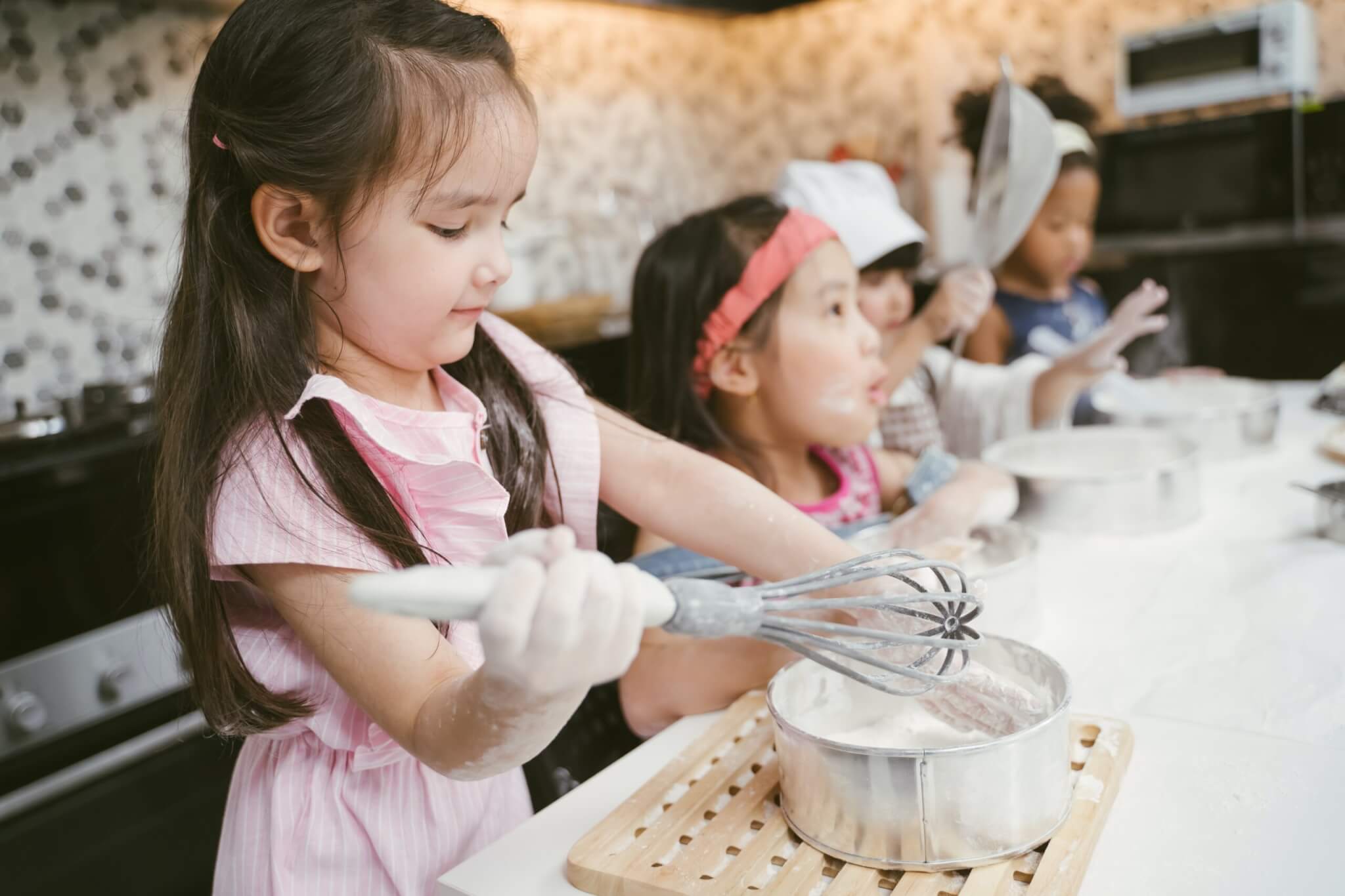 Young children cooking and baking