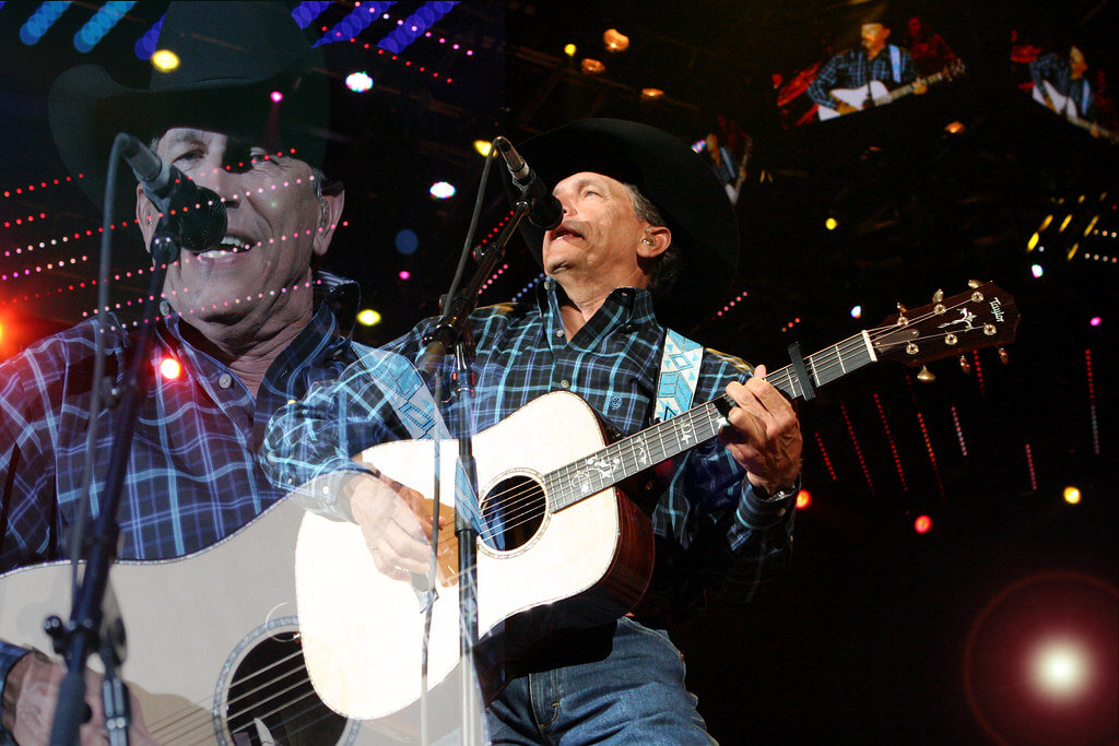 George Strait performing live with a guitar