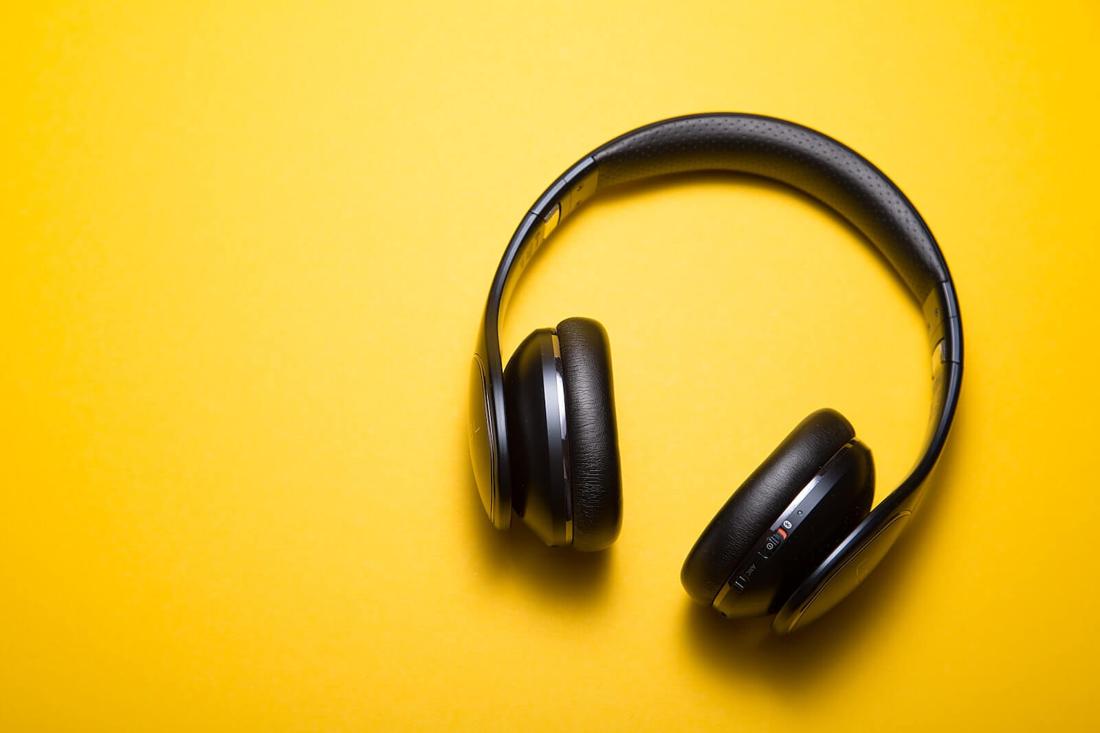 black headphones with a yellow background