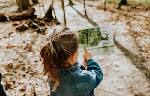 young girl reading map