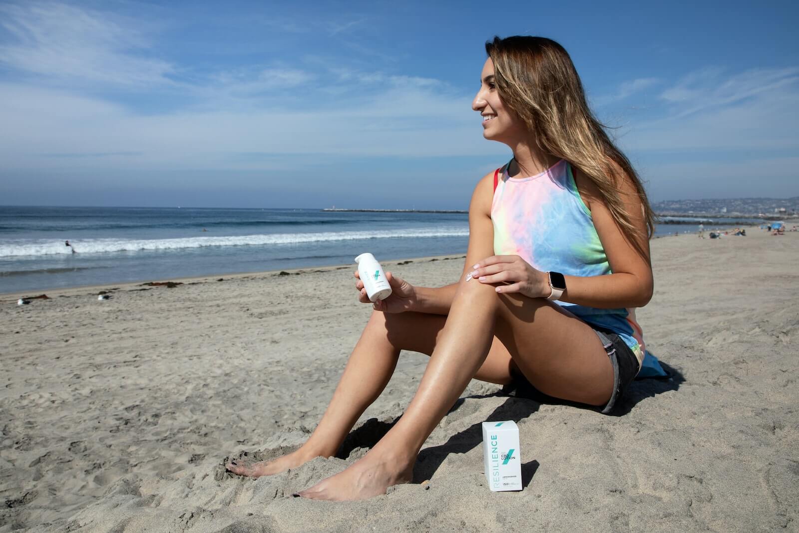 woman applying sunscreen on the beach