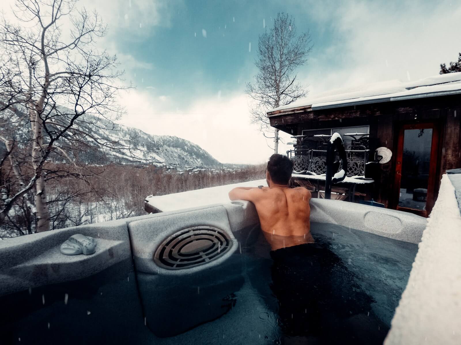 Man in a hot tub during winter