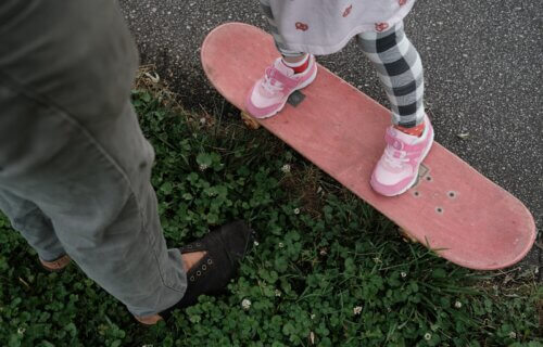 teaching a child to skateboard
