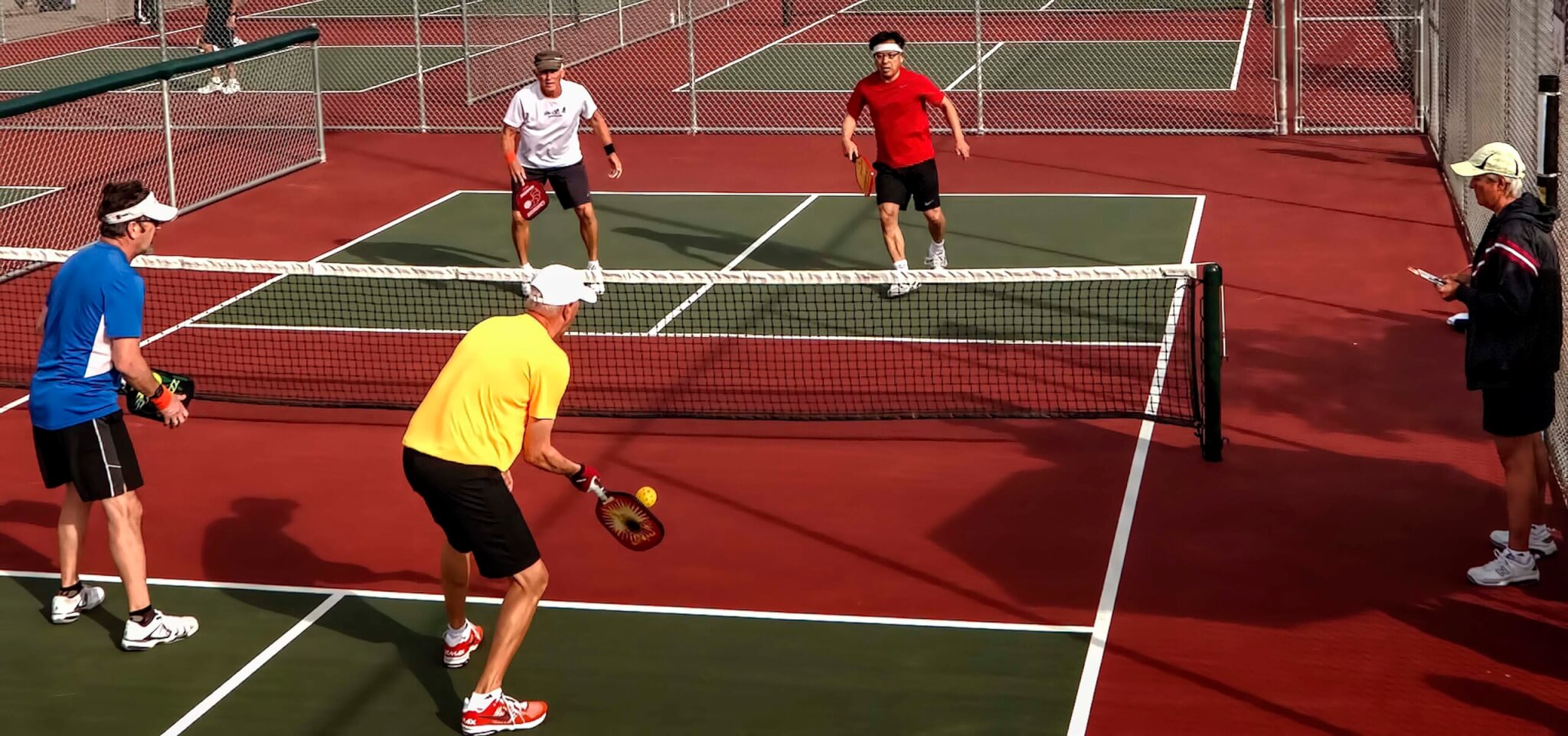 4 players in a pickleball game