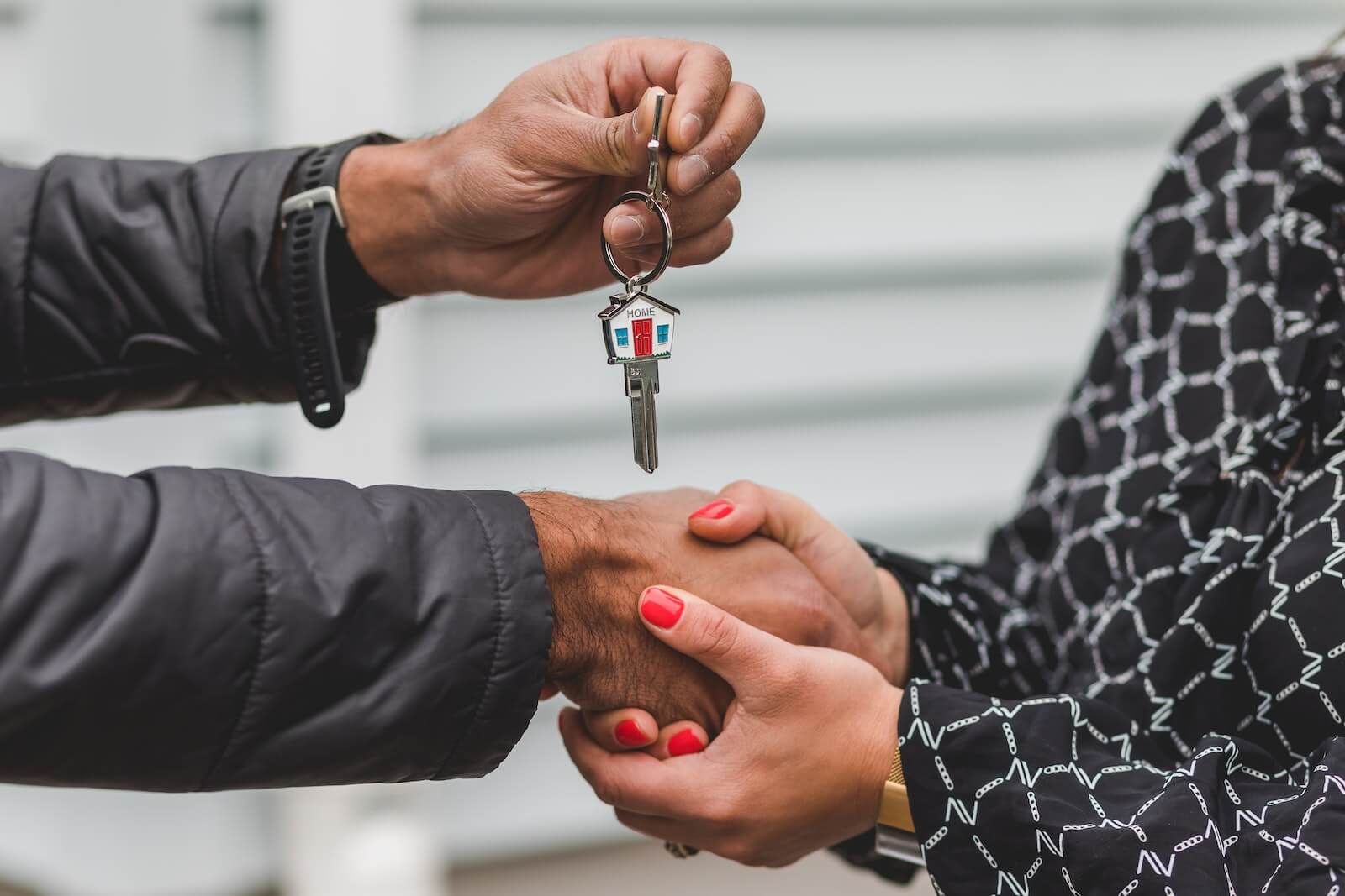 A real estate agent passing keys to a homeowner