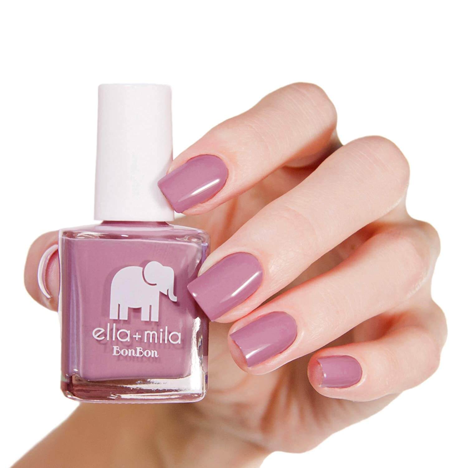 woman's hand with pink nails holding pink nail polish