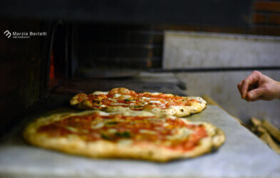 Pizzas in an oven at L'Antica Pizzeria da Michele in Italy.