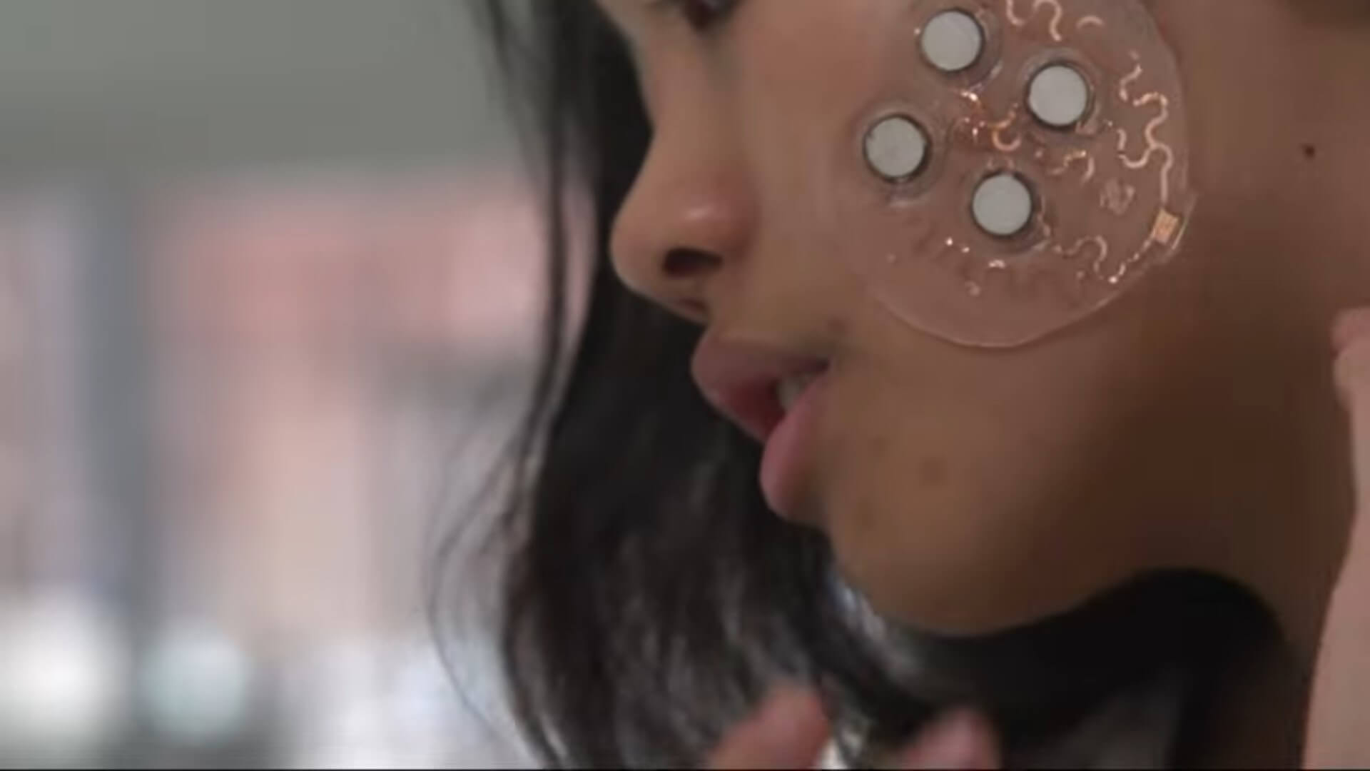 MIT ultrasound patch on a woman's face.