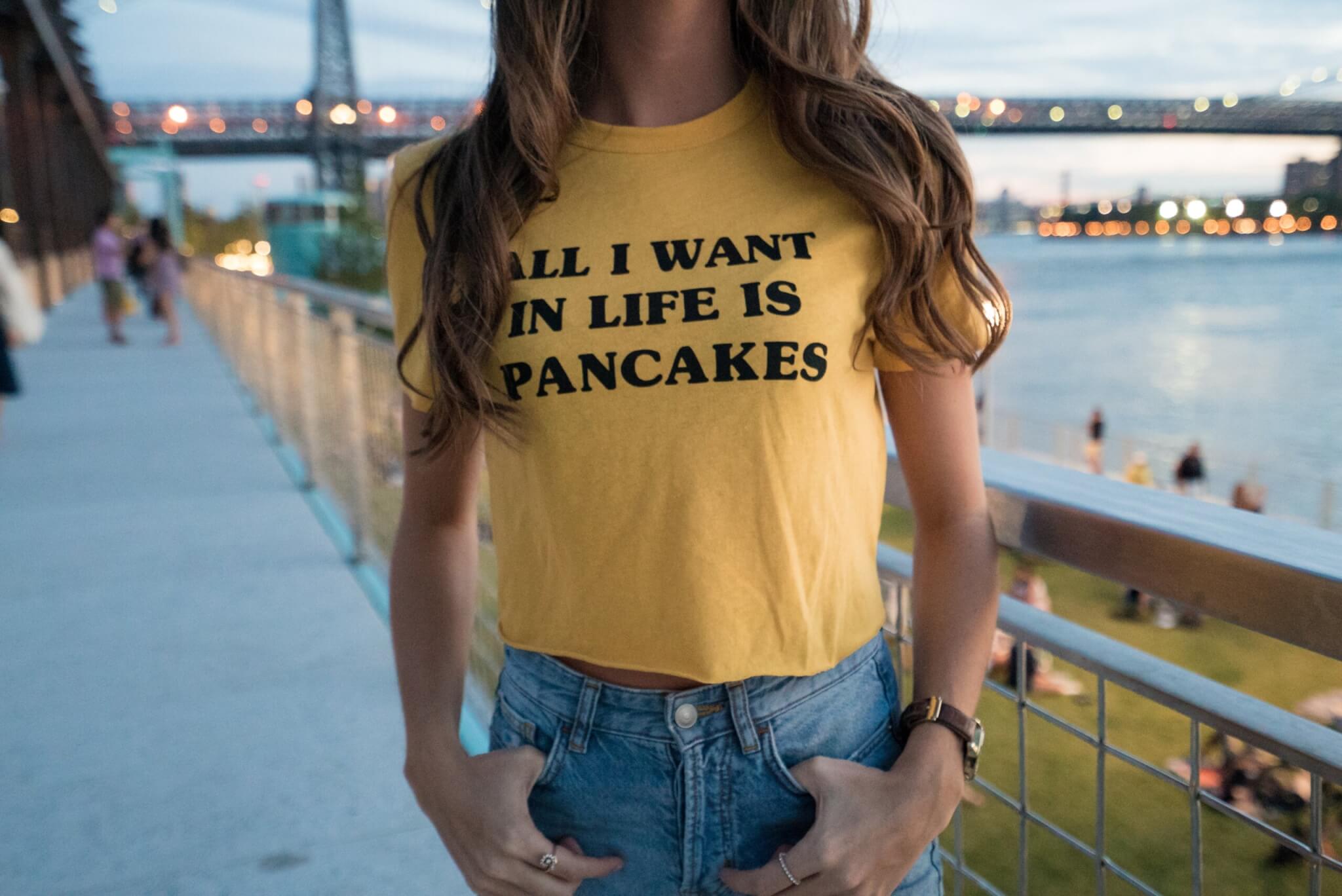 Woman wearing tshirt with pancakes quote