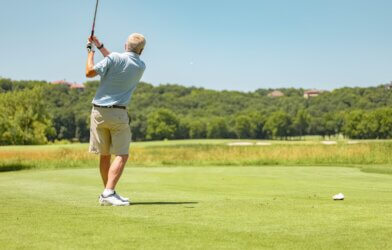 older adult playing golf