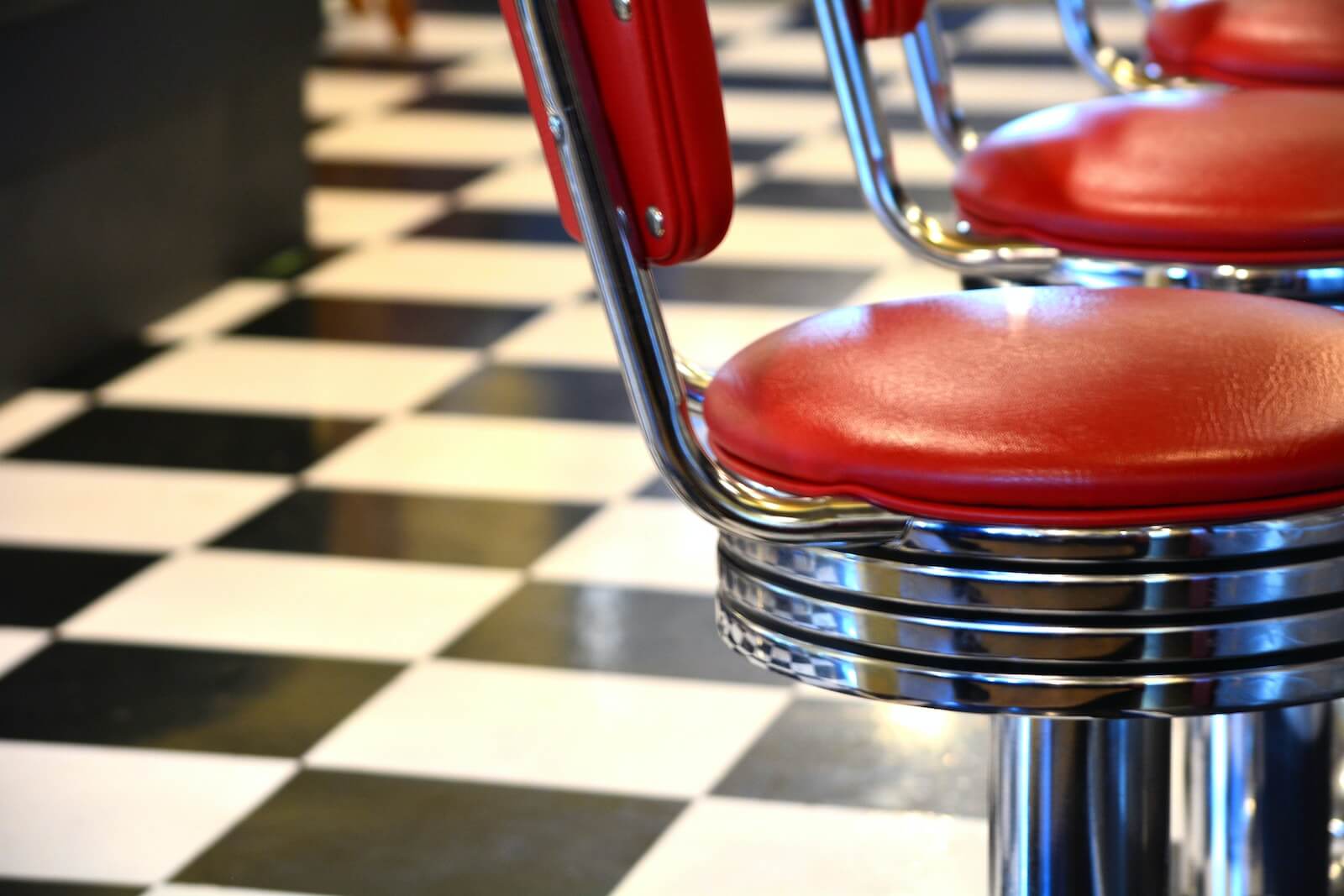Vinyl diner stools and checkered tile floor
