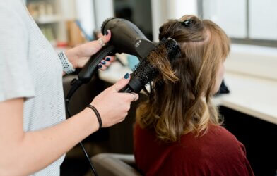 A woman having her hair blown dry at a salon