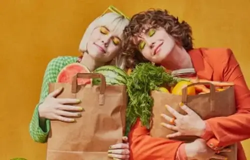 women with grocery bags full of produce