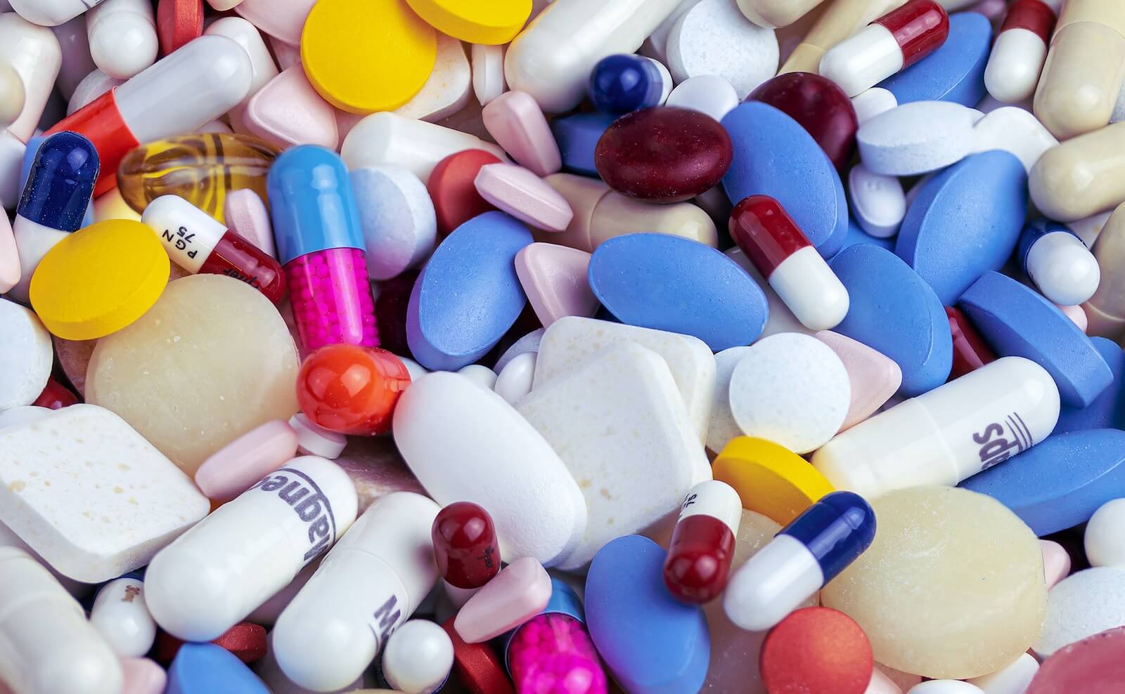 A pile of different colored pills