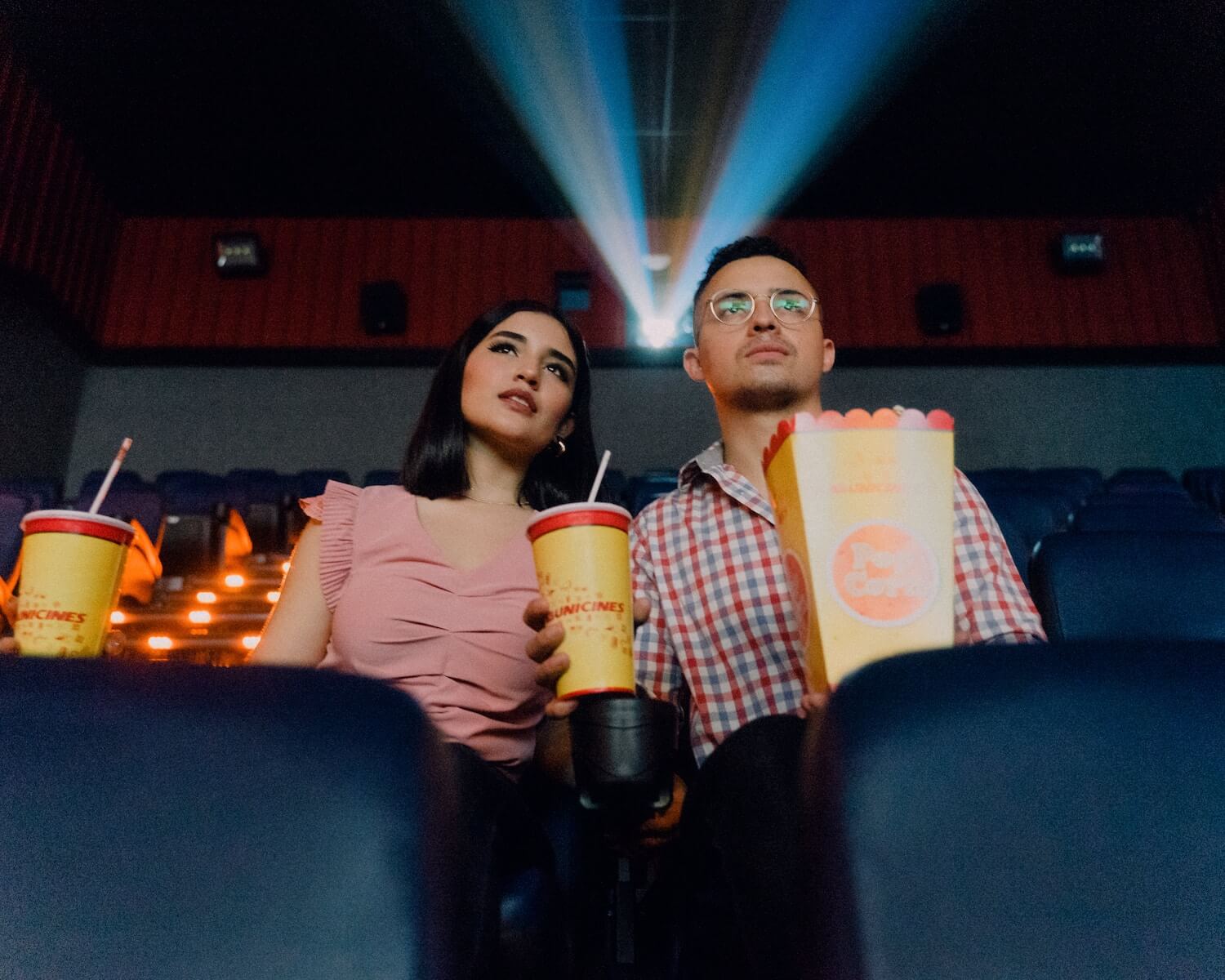 2 people sitting in a movie theater