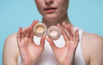 Woman holding jars of color corrector