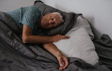 Elderly Man Sleeping in Bed, Sleep Apea impact on brain health