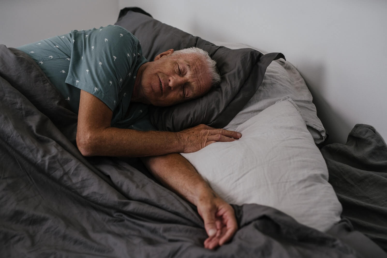 Elderly Man Sleeping in Bed.