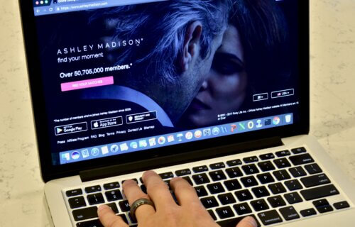 Married man opening Ashley Madison website on his computer.