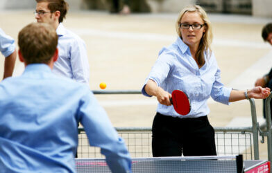 Men and women playing ping-pong