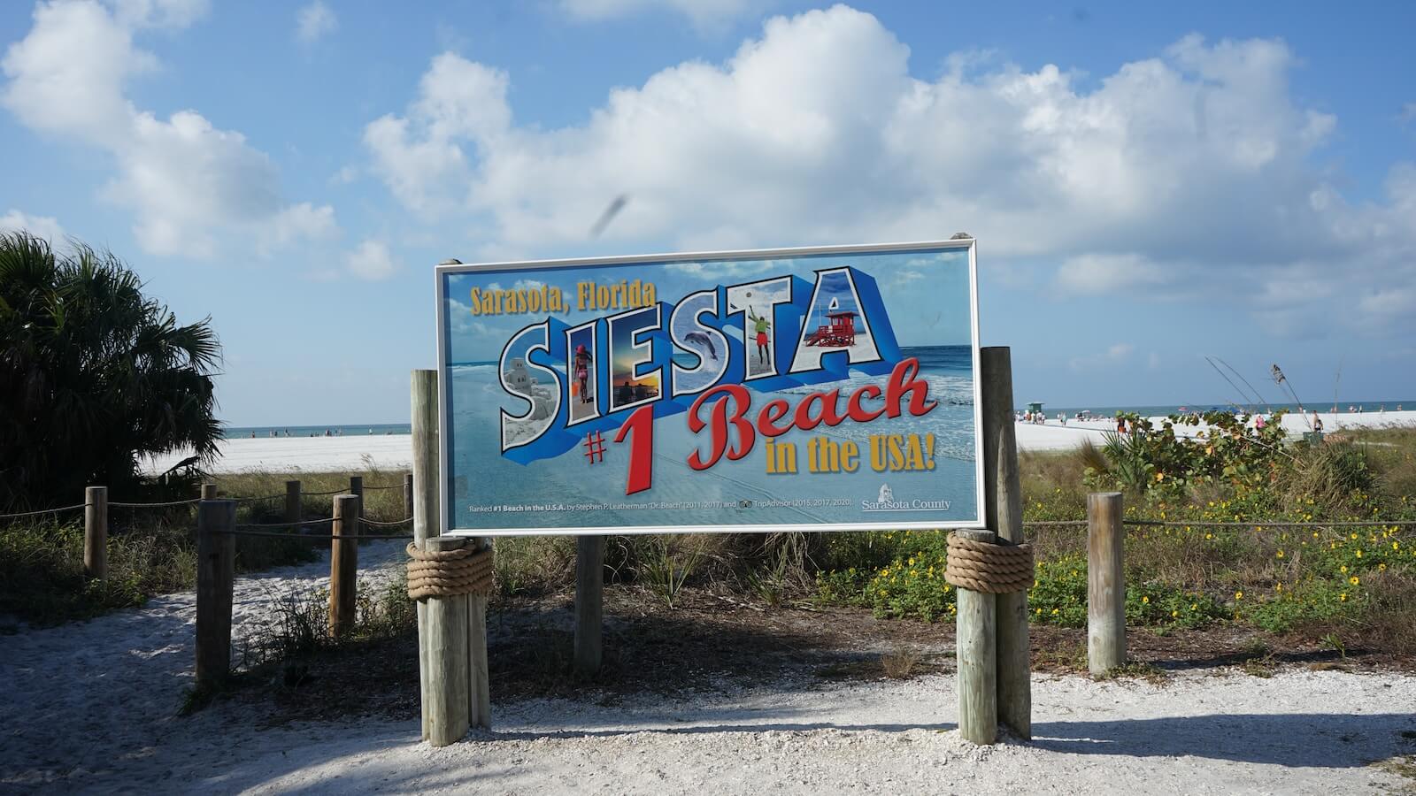 a sign for a restaurant on the beach