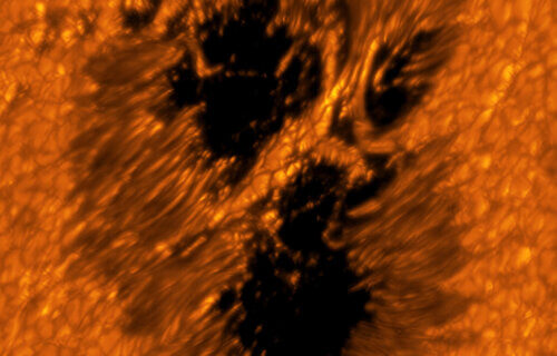 A light bridge is seen crossing a sunspot’s umbra from one end of the penumbra to the other