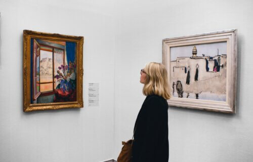Woman looking at a painting in an art gallery.