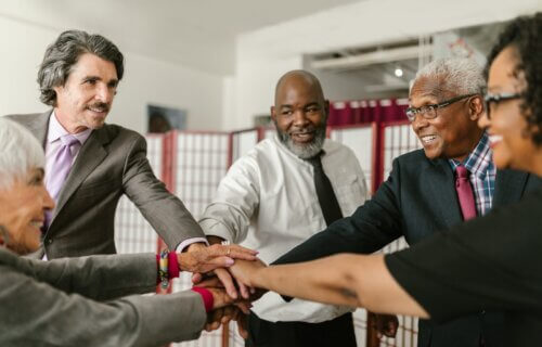 Older adults joining hands