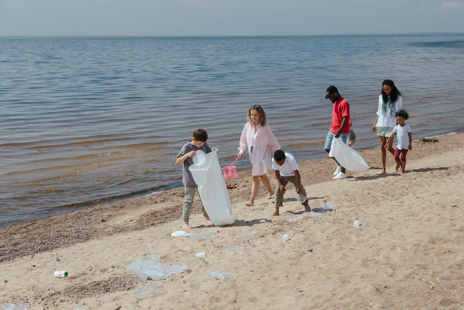 Children at the beach cleaning litter
